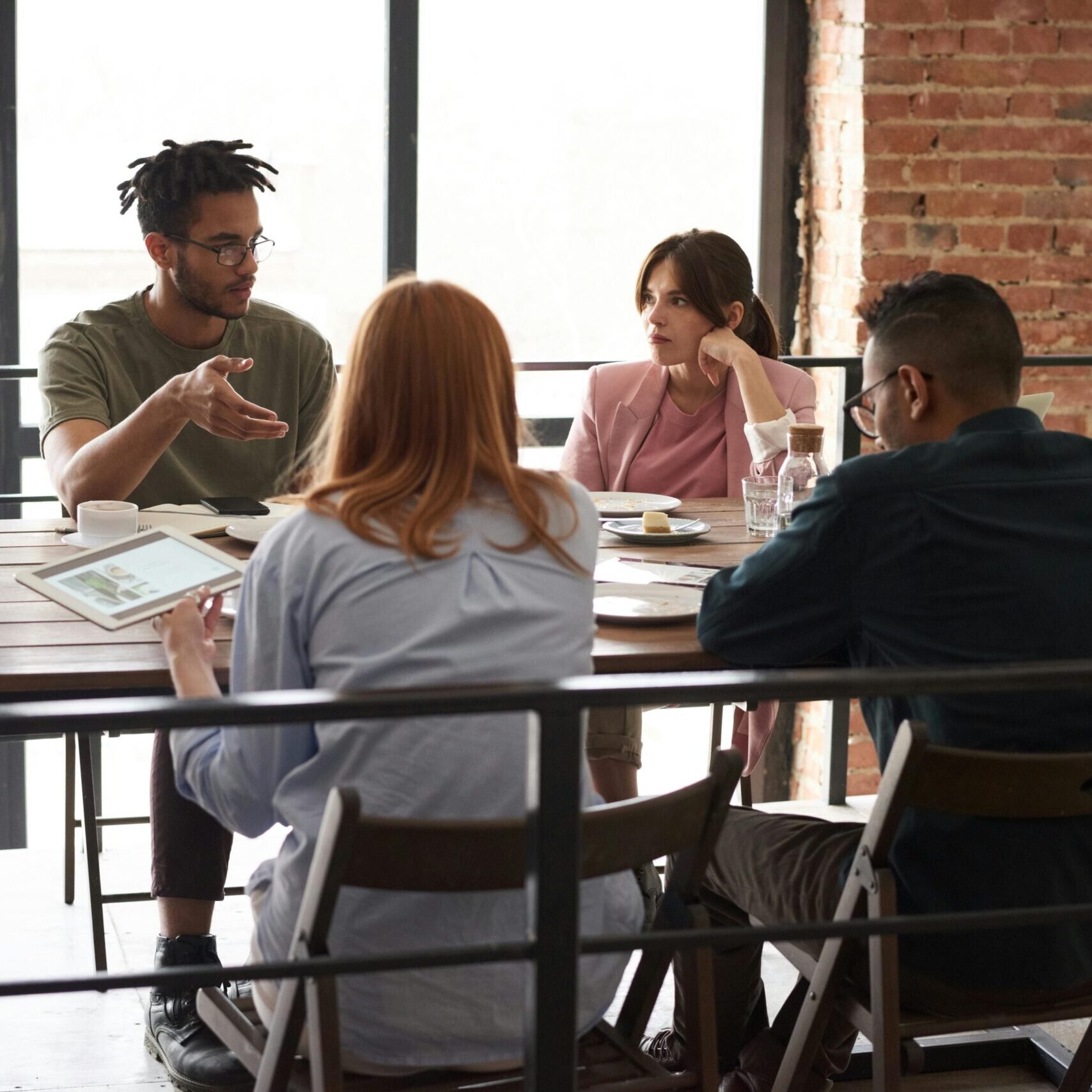 Diverse team sitting at a table having a team meeting